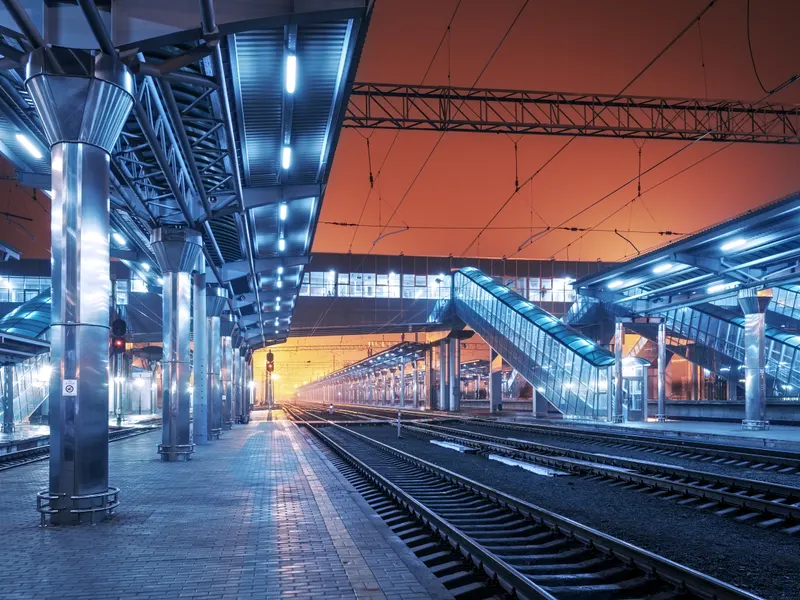 Railway station platform illuminated at dusk