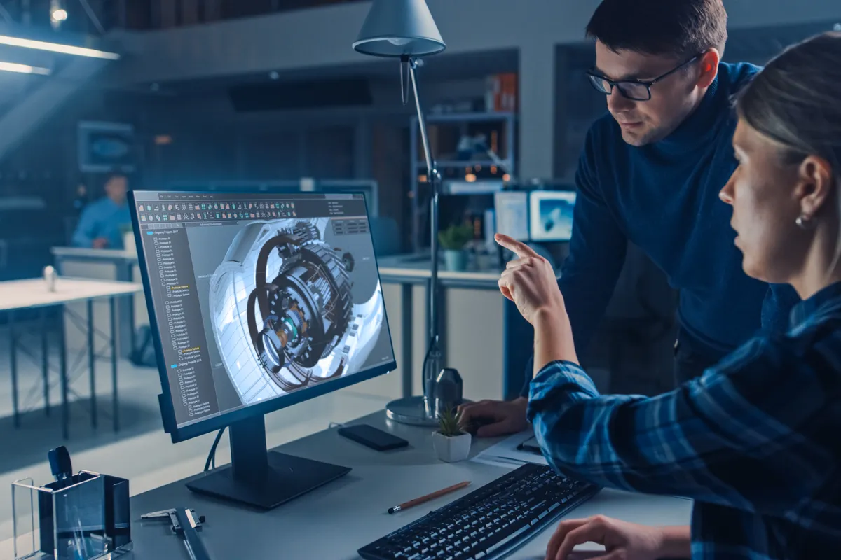 Engineers reviewing a 3D engineering model on screen